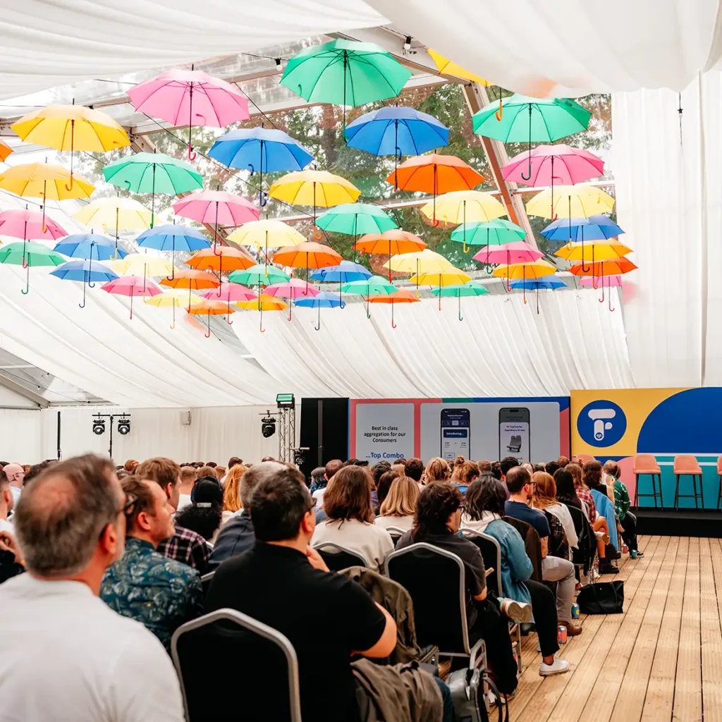Conference in marquee with colourful umbrellas
