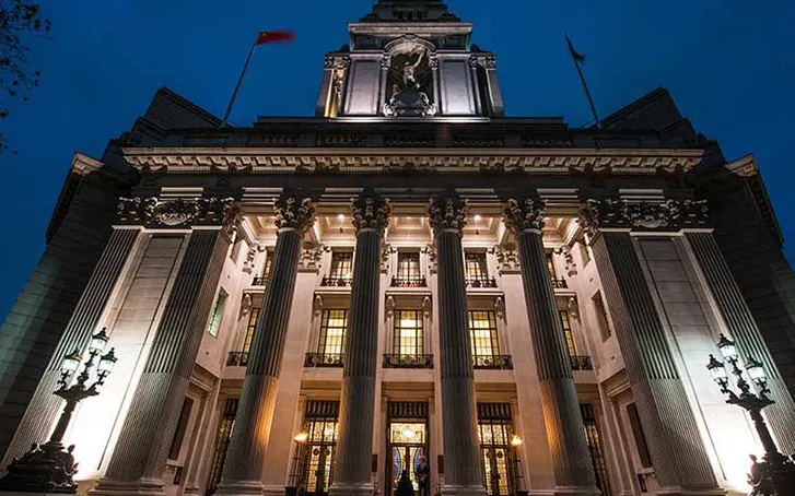Blenheim Palae photographed from low down, at night, with lighting beaming up the front of the building