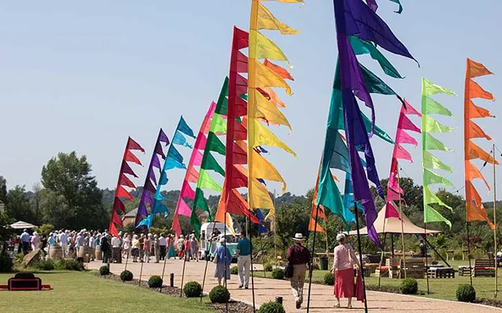 Multi-coloured flags lining a path leading to a corporate event Brand and marketing events