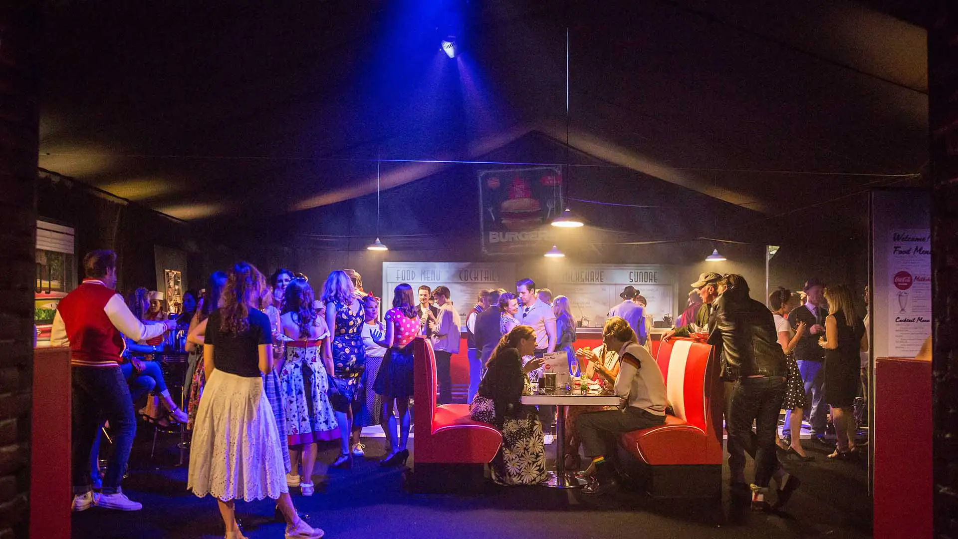 A party venue decorated in a 1950s style for an immersive party experience.