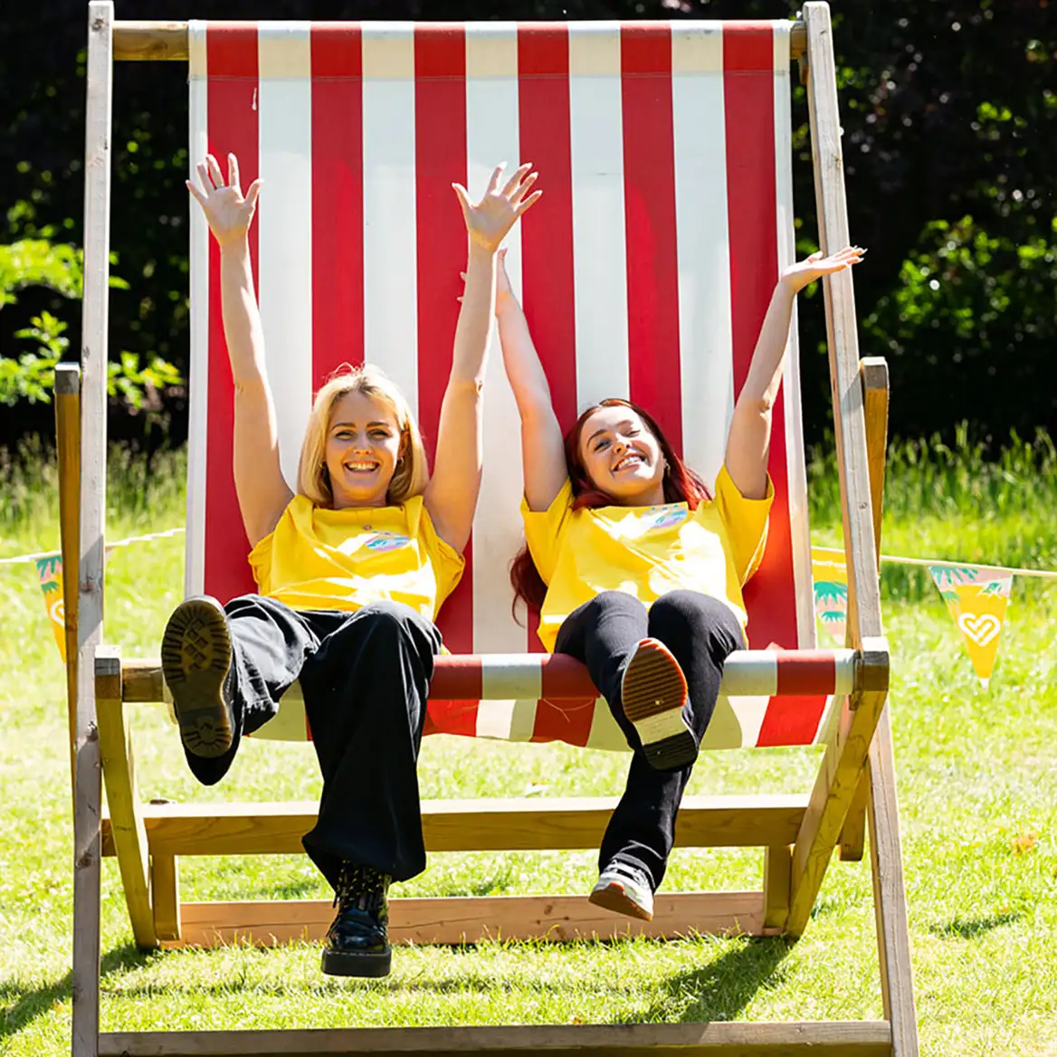 Summer party over large deckchair prop with event staff