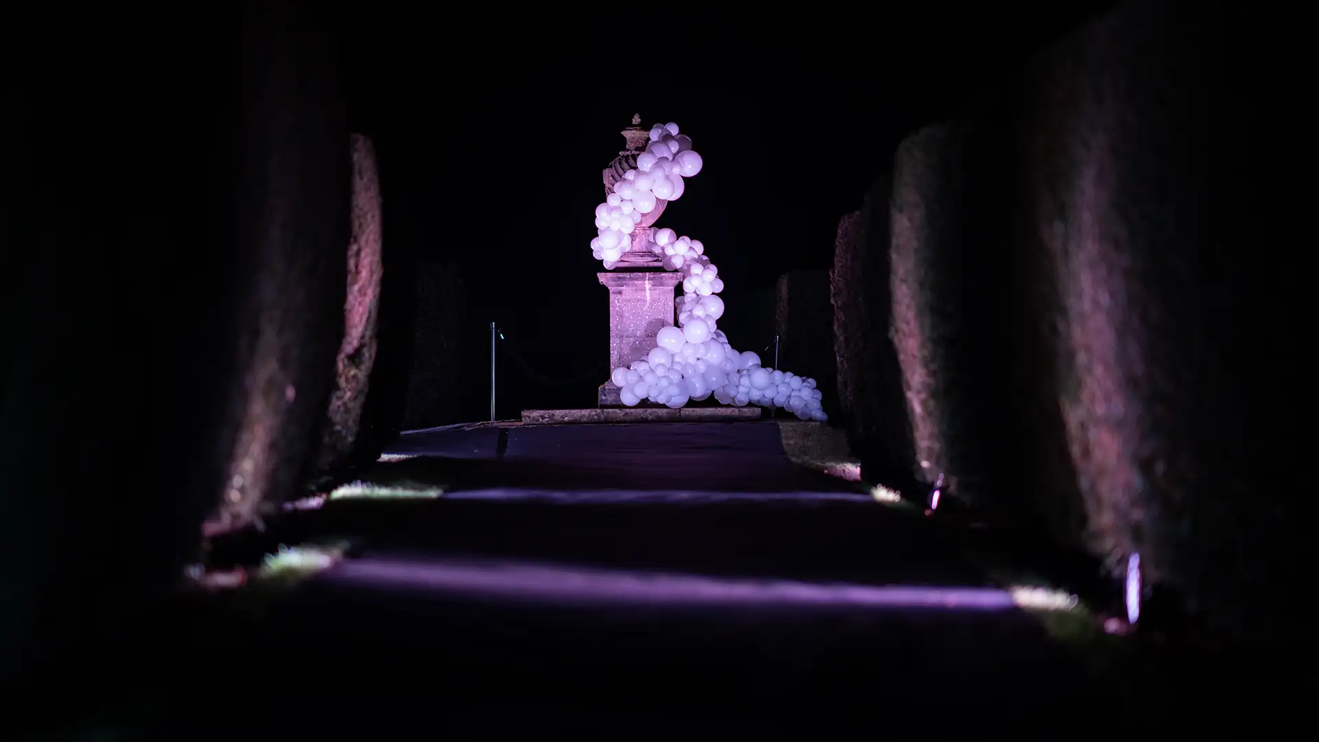 Stunning balloon arrangement around garden statue