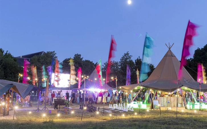 Company Festival party site including tipis and festival flags and site lighting