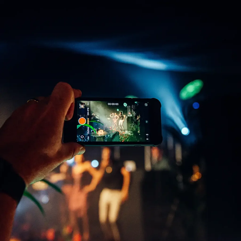 A person films the band on iPhone