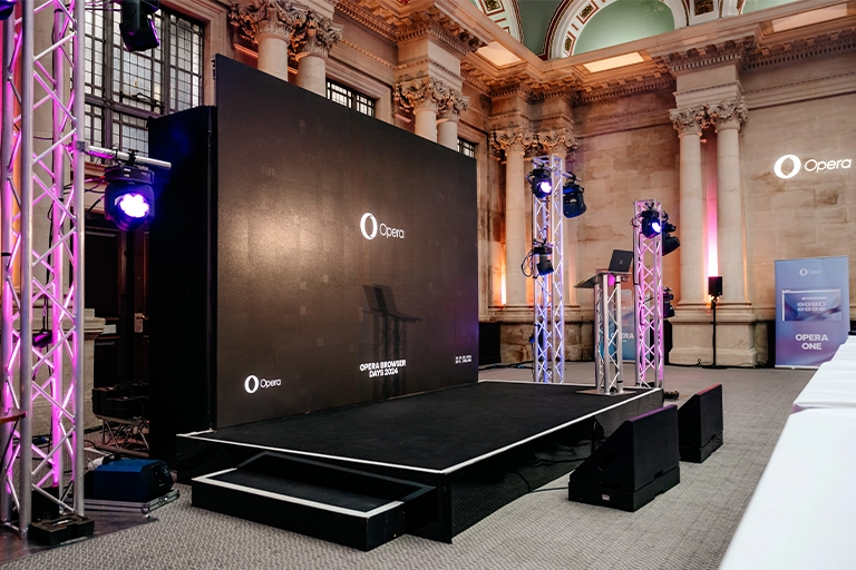 Large LED screen with stage, trussing and lighting for corporate event