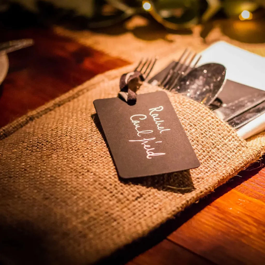 Rustic hessian napkin for table setting with handwritten name tag