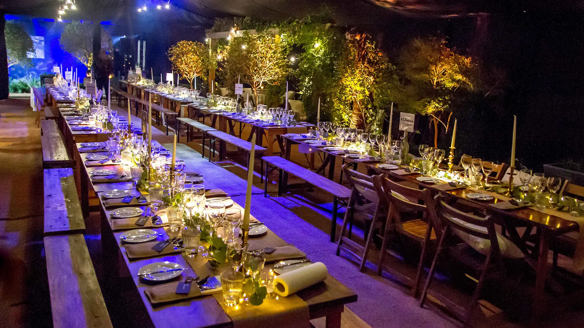 Trestle tables with rustic and garden theming in marquee
