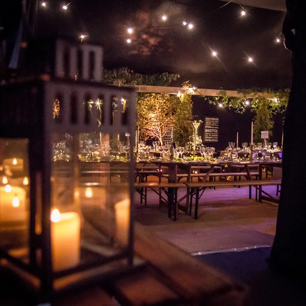 Lantern and candles along with black starlit cloth to light the marquee