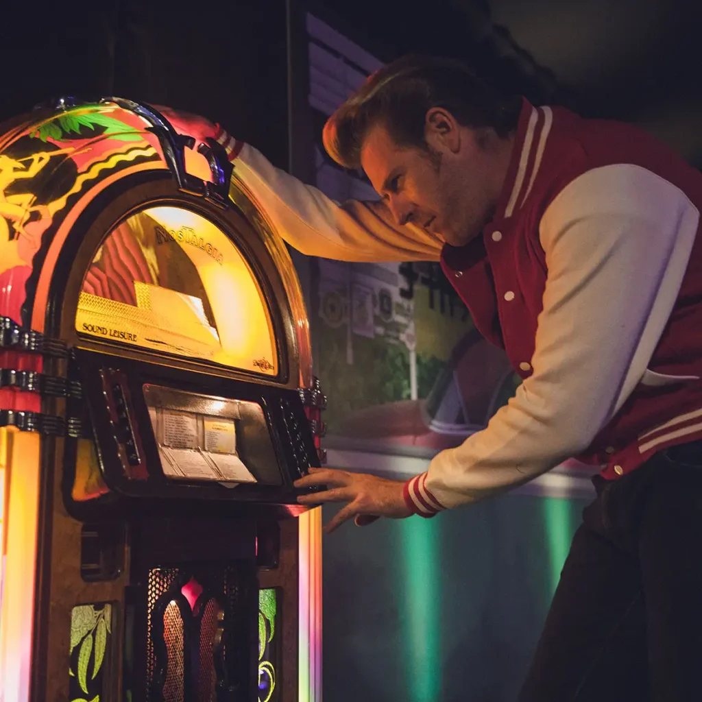 Juke box with immersive 1950s actor choosing music