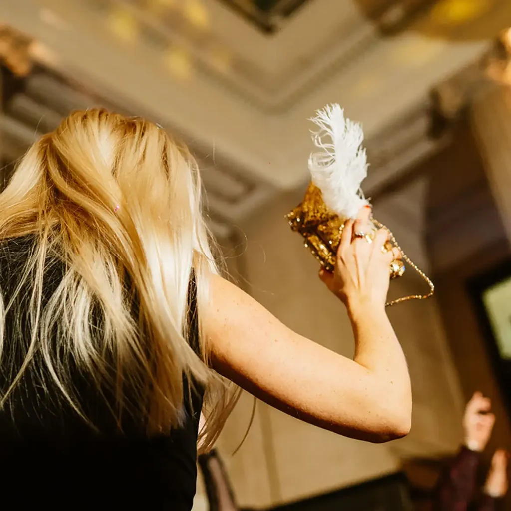 Party guest dancing with white feather