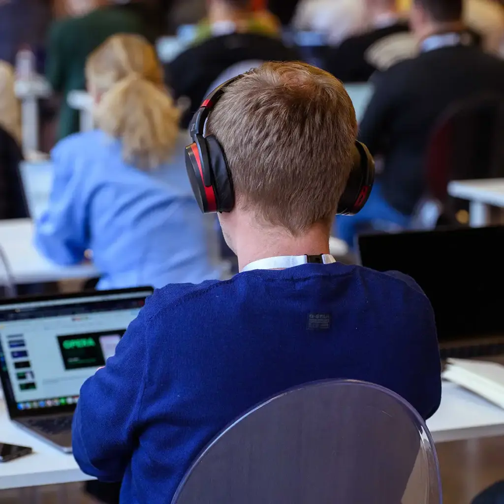 Guest listens to conference with headphones for simultaneous translation