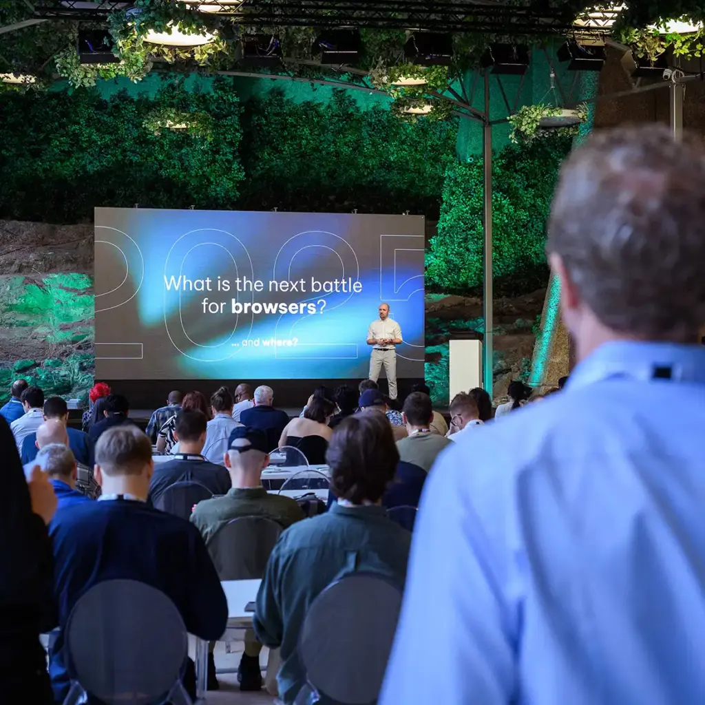 Attendees watch a presentation
