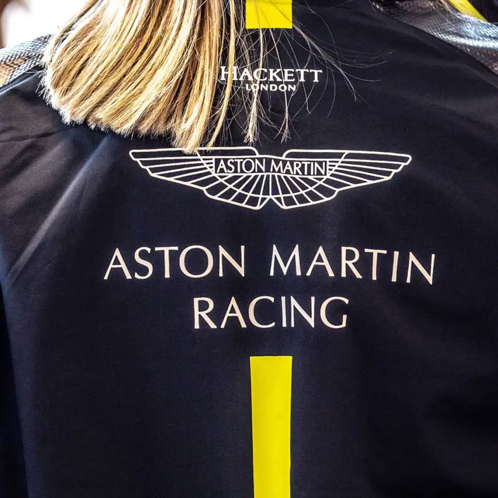A lady wearing a luxury Aston Martin racing jacket