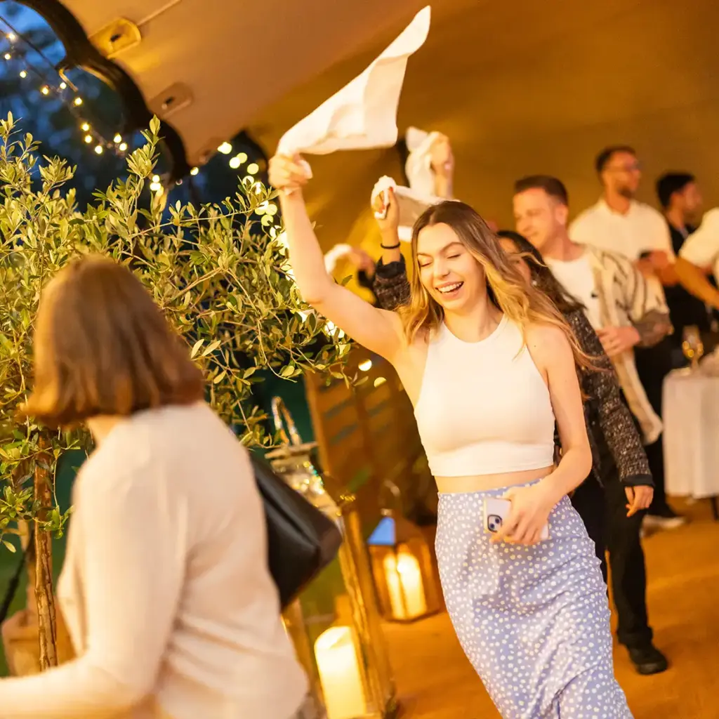 Guests do the Conga and wave napkins