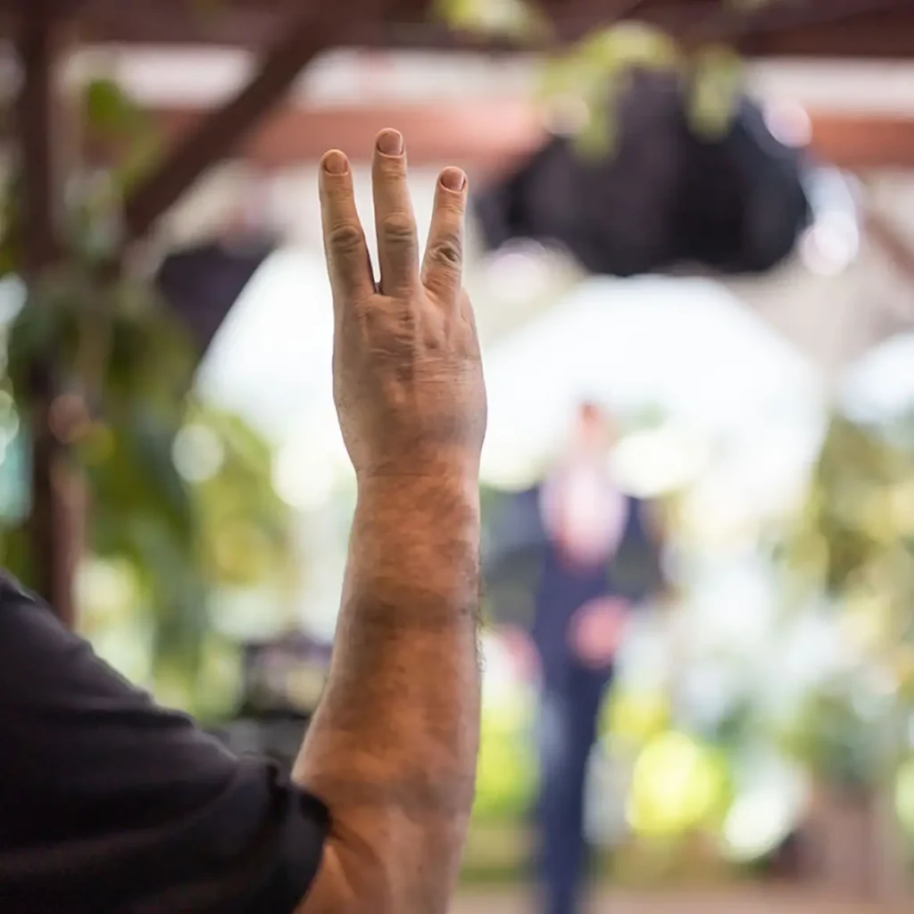 Production manager holding three fingers up to count down