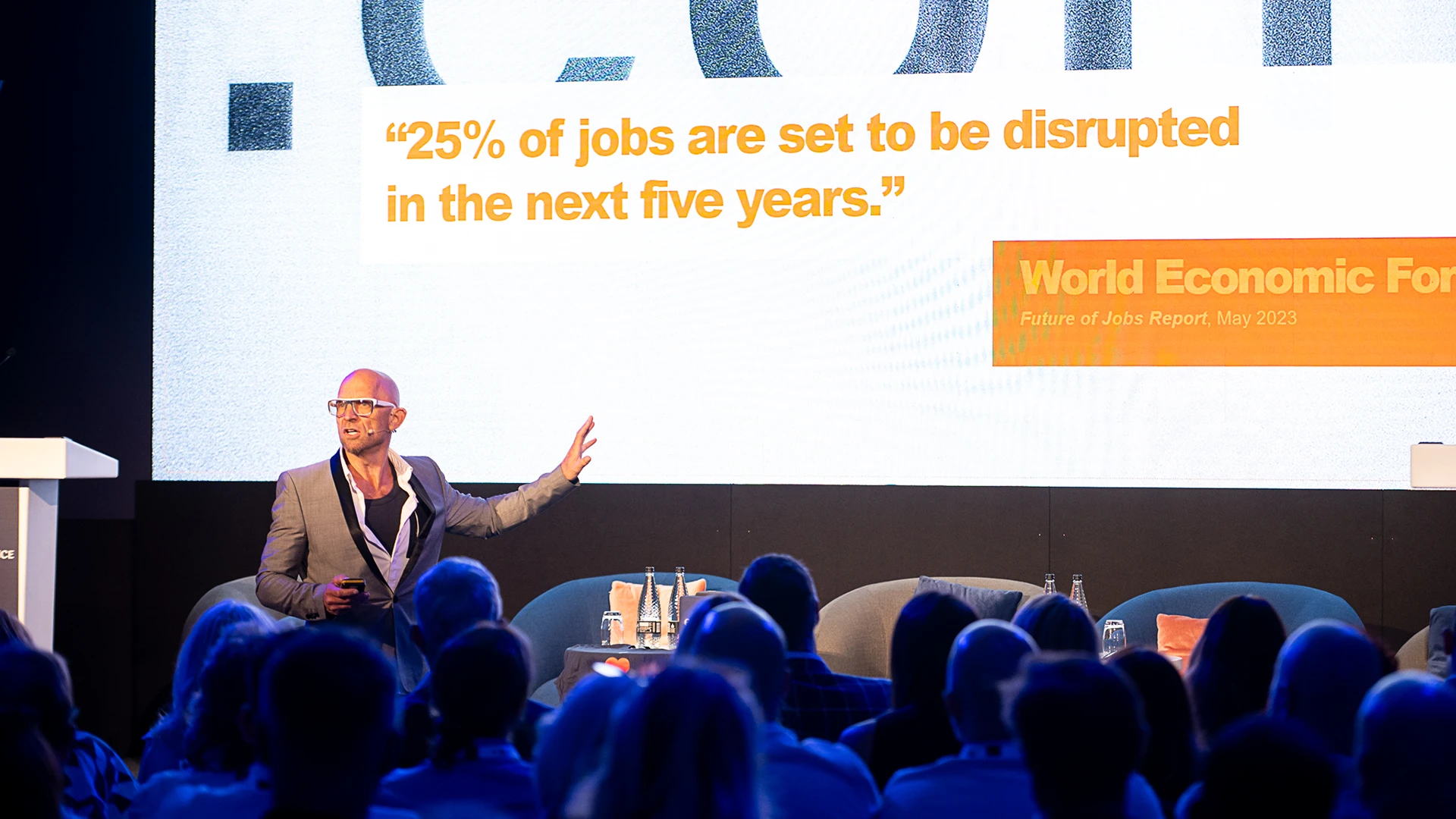Jason Bradbury keynote speaker at conference with large LED wall
