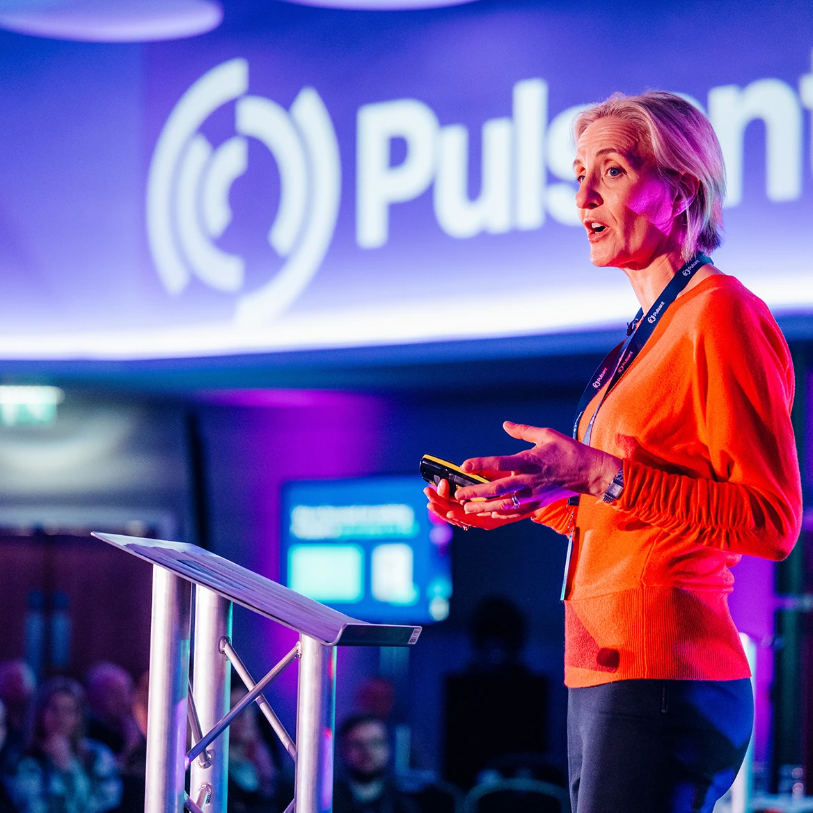 speaker presenting on stage at kick off event